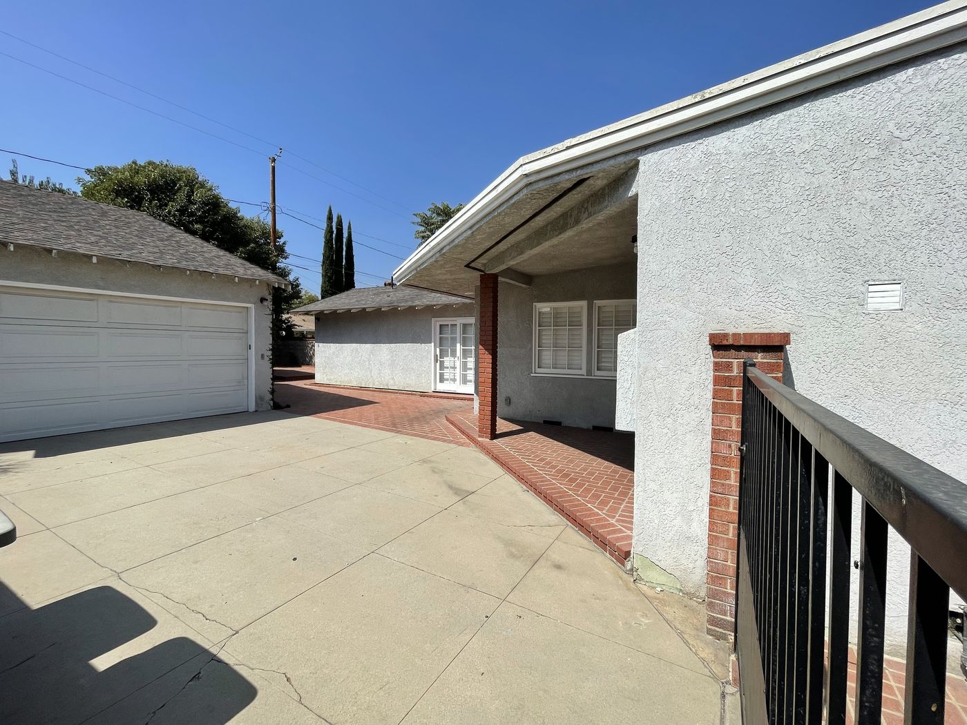 Aged brick and concrete courtyard before the outdoor remodel